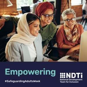 Three diverse women are sitting together looking at a computer screen. They are smiling. Beneath is the word empowering.