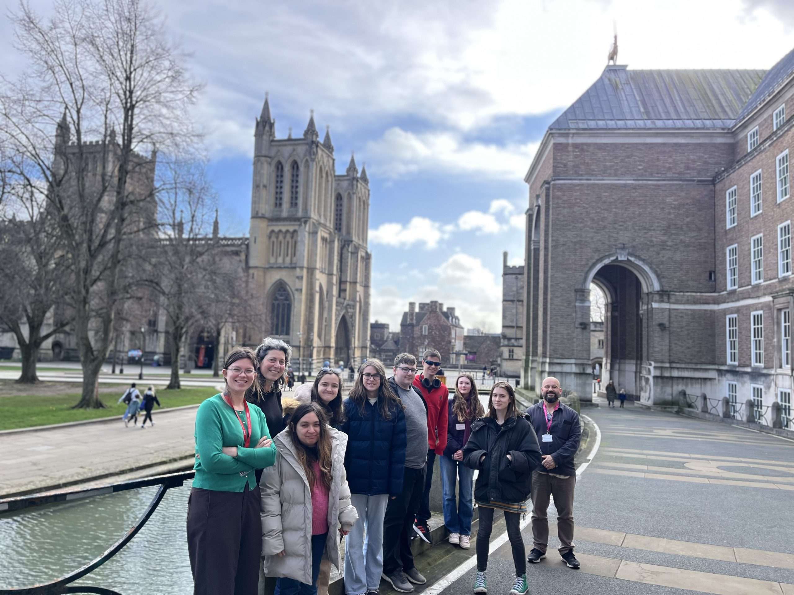 A photo of the staff and interns of the Birstol Project Pilot supported internship programme outside of the Bristol City Hall with the cathedral in the background.