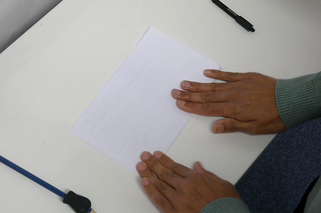 Someone is folding a ballot paper.