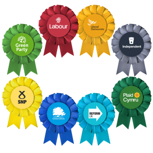 Eight different coloured rosettes that represent different political parties.