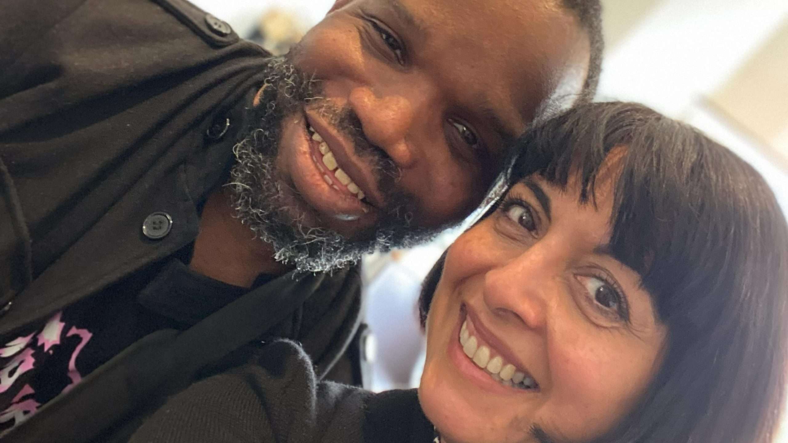 Headshot of Paul Christian and Saba Salman. They are smiling at the camera in a selfie.